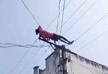 Drunk man climbs electric pole