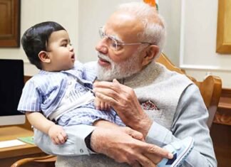 PM Modi cradles little Omy, melts hearts across social media PM Modi cradles little Omy