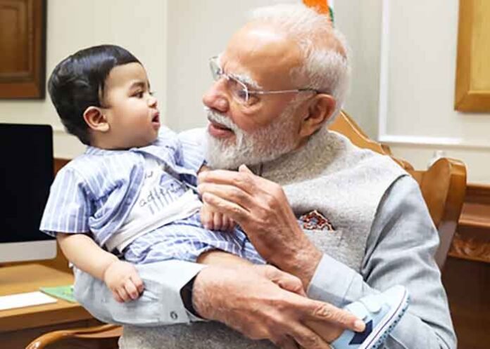 PM Modi cradles little Omy