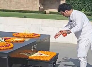 BJP MLA Ravinder Singh Negi sprinkles Ganga water at Rajghat