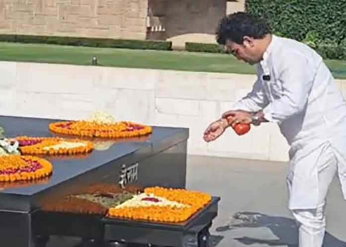 BJP MLA Ravinder Singh Negi sprinkles Ganga water at Rajghat