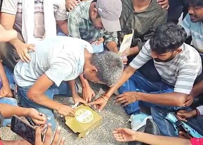 Students cut birthday cake for Hemu Chacha